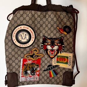 Gucci GG Supreme Courier backpack with patches.